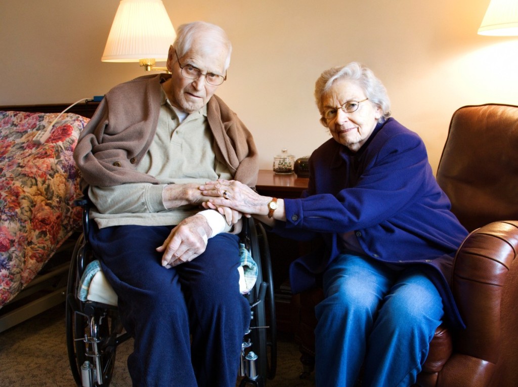 Elderly Caucasian couple in bedroom at retirement community center.