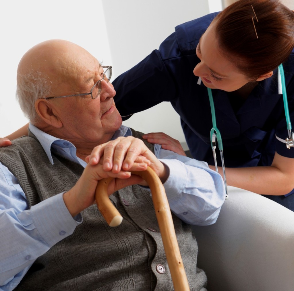 Senior man being visited by a nurse at home