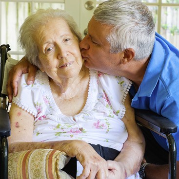 CROPPEDONECaregiver_Mom&Son_Hispanic_Frail_Wheelchair_Home_ThinkstockPhotos-494781855