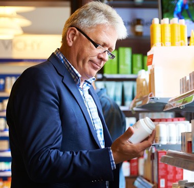 CROPPEDMan-drug-store-pill-bottle-meds_Stock-471744337