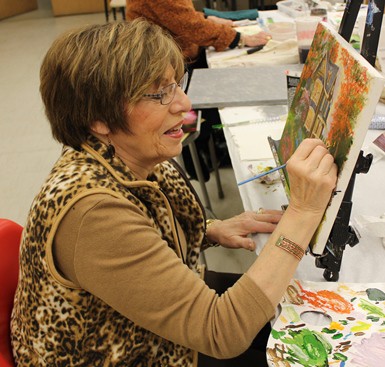 A woman paints at KleinLife: Northeast (Photo by Linda L. Riley)