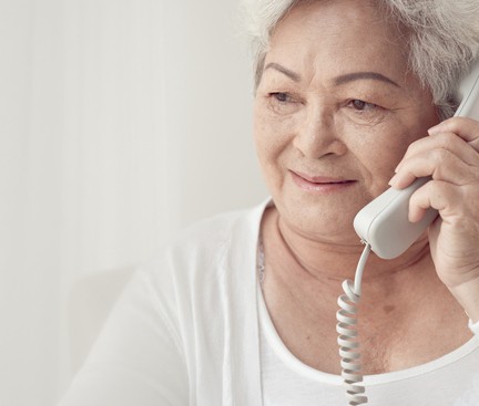 Asian woman talks on telephone in Thinkstock photo.