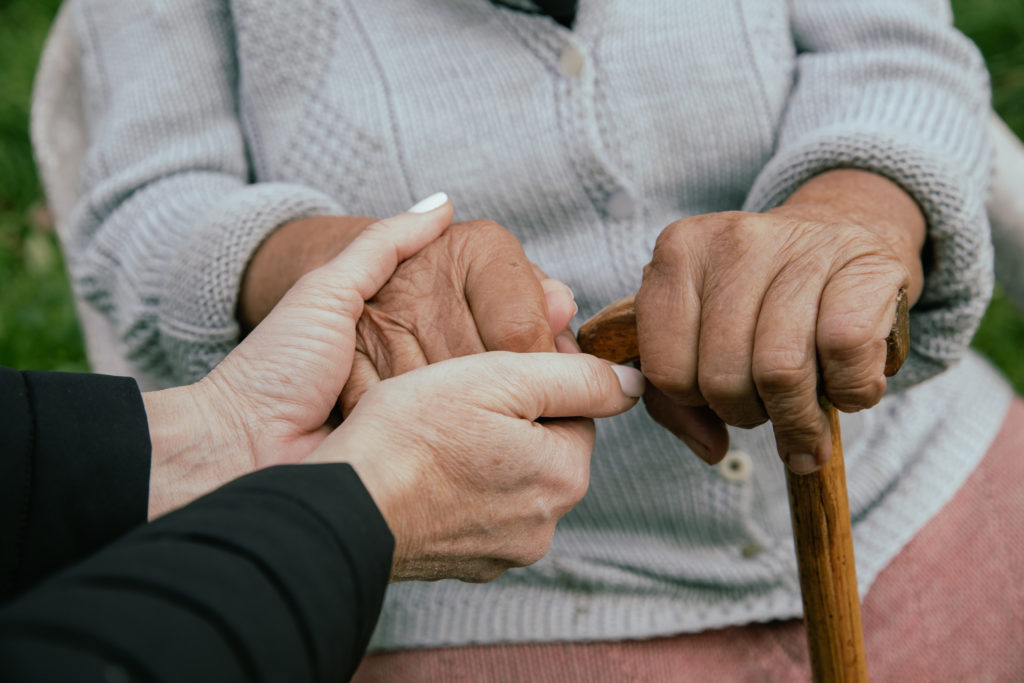 Closeup Photo of Women Holding Hands